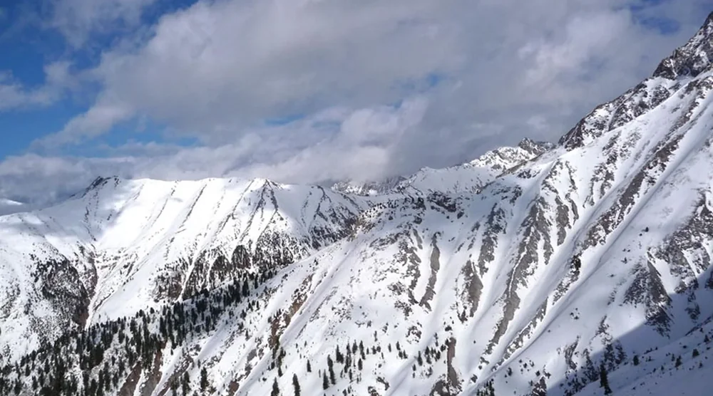 Snow-covered mountains and slopes in Tunka Valley near Arshan