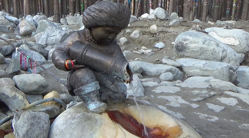 Bronze statue of a child pouring water from a jug at an Arshan mineral spring