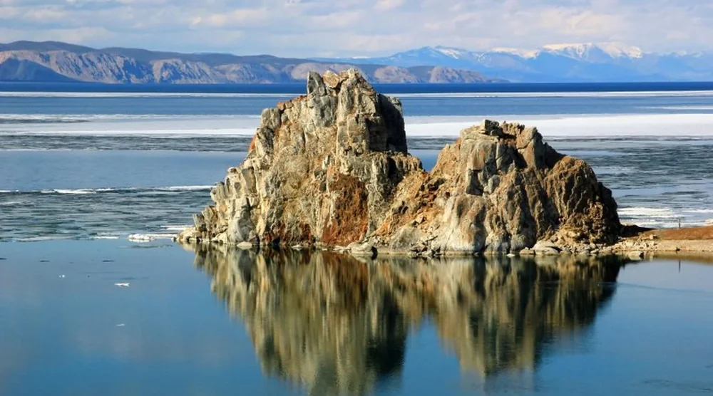 Scenic rock formation reflecting in the clear waters of Lake Baikal on Olkhon Island