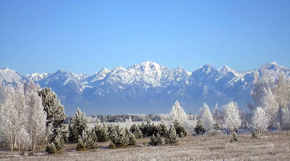 Snow-capped mountains and frost-covered trees in Tunka Valley near Arshan