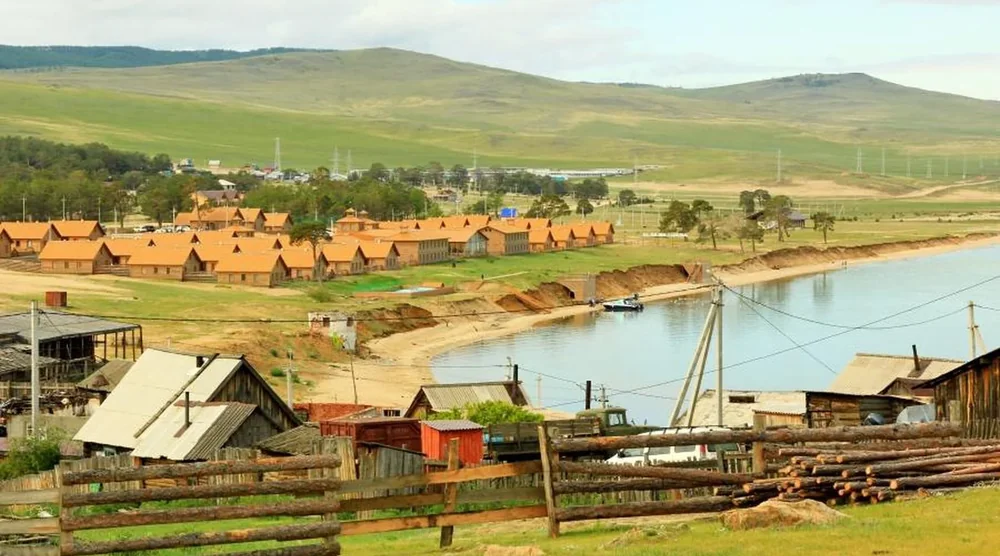 Scenic view of Khuzhir village houses and wooden fences overlooking Lake Baikal on Olkhon Island