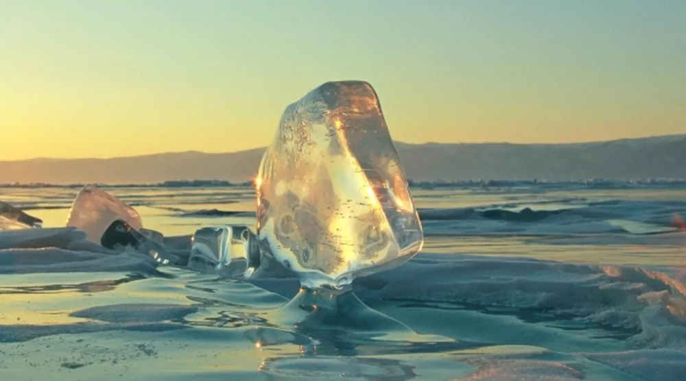 Clear blue ice chunk on Lake Baikal during a winter tour